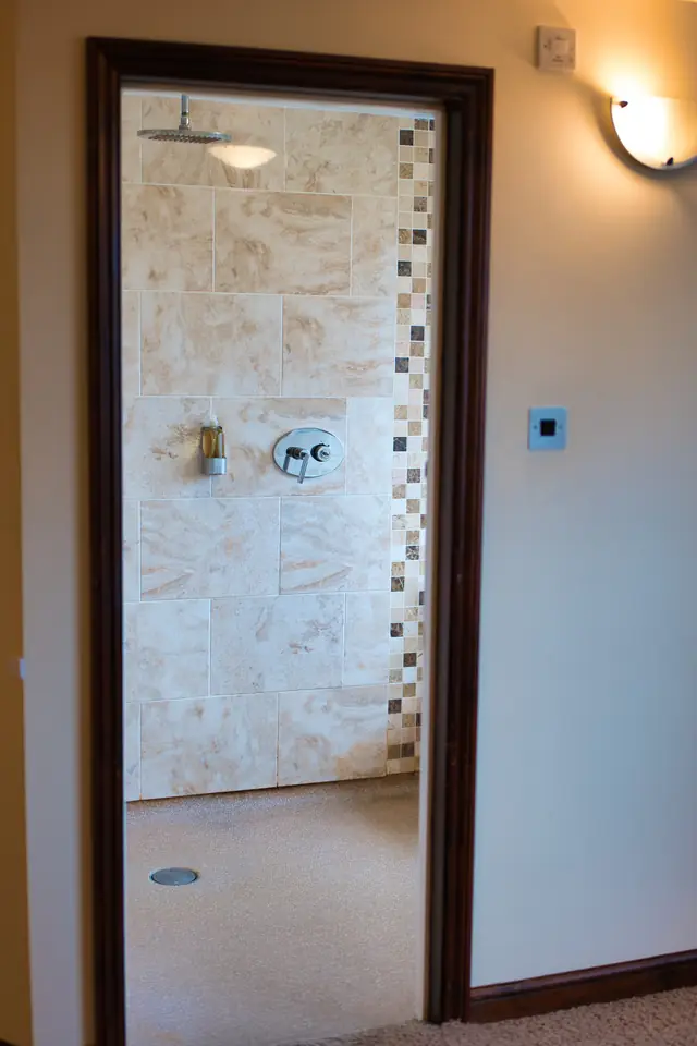 View through a doorway into the suite’s tiled walk-in wet room